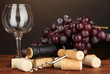 Wine and corks on wooden table on brown background