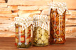 Delicious marinated mushrooms in glass jars,