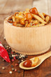 Mushrooms in bowl, on wooden background