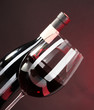 Wine in glass and wine bottle close-up on dark background