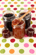 Tasty jam in banks on table