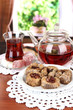 Sweet baklava on plate with tea on table in room