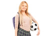 Photo: A young female student with bag holding a soccer ball A young female student with bag holding a soccer ball