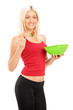 A young blond woman eating a salad