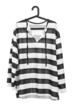 A studio shot of a black and white striped prison uniform on a h