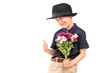 A cute little boy with a hat holding bunch of flowers