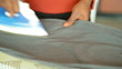 African american maid ironing washed up clothes