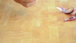 Caucasian man cutting onion on yellow colored wooden desk