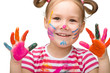 Portrait of a cute girl playing with paints