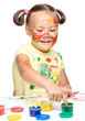 Portrait of a cute girl playing with paints