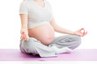 pregnant woman sitting in yoga lotus position