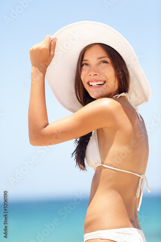 Photo: Summer beach woman beautiful with sun hat Summer beach woman beautiful with sun hat