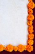 Frame of marigold on exotic dark red background