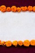 Frame of marigold on exotic dark red background