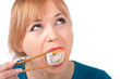 Photo: beautiful young woman eating sushi with chopsticks beautiful young woman eating sushi with chopsticks