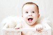Photo: happy baby in white basket happy baby in white basket