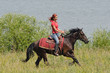 Photo: Equestrian woman horseback riding on beach Equestrian woman horseback riding on beach