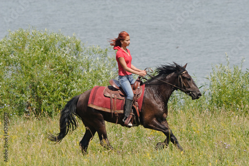 Photo: Equestrian woman horseback riding on beach Equestrian woman horseback riding on beach