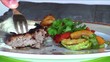 Having lunch outdoors, eating beef (close up)