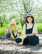   women with child works at vegetables garden