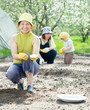 family sows seeds in soil