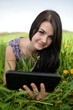 Portrait of a smiling brunette using a touchpad