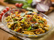 pasta with eggplants zucchinis tomatoes and curry, selective foc
