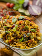Foto: pasta with eggplants zucchinis tomatoes and curry, selective foc pasta with eggplants zucchinis tomatoes and curry, selective foc