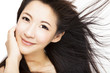 Photo: beautiful Woman face with hair motion on white background beautiful Woman face with hair motion on white background