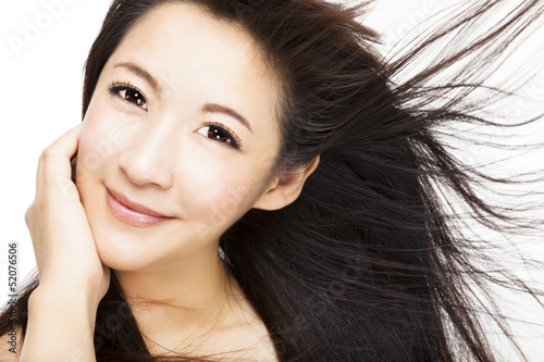 Photo: beautiful Woman face with hair motion on white background beautiful Woman face with hair motion on white background