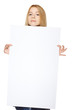 teenage girl holding peeking out the edge of blank banner
