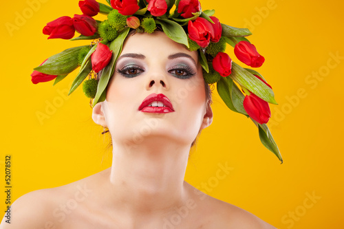 Photo: beauty woman portrait with wreath from flowers on head over yell beauty woman portrait with wreath from flowers on head over yell