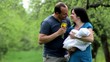 Laughing happi parents with a child in the park.