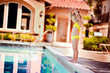 Photo: Pretty little girl playing in outdoor swimming pool and have a f Pretty little girl playing in outdoor swimming pool and have a f