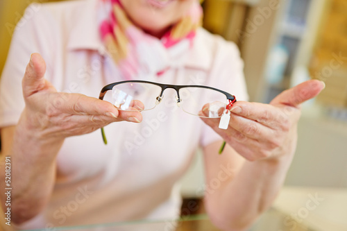 Photo: Hands of optician offering glasses Hands of optician offering glasses