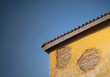 Antique wooden door on yellow cement wall