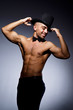 Muscular man in dark studio