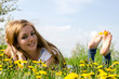 Young woman barefoot between dandelions
