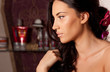 Photo: Portrait of young brunette woman with curly hair in the room Portrait of young brunette woman with curly hair in the room