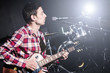 Photo: Man playing guitar during concert Man playing guitar during concert