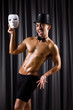 Muscular actor with mask against curtain