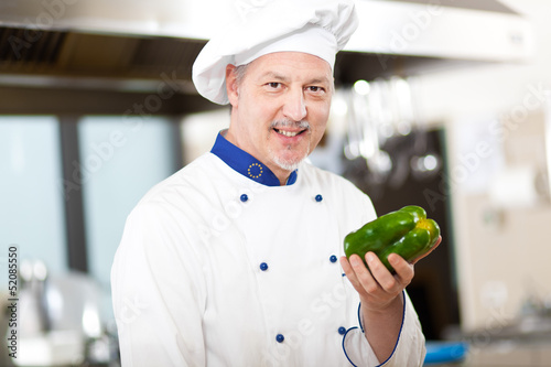 Photo: Chef holding a pepper Chef holding a pepper