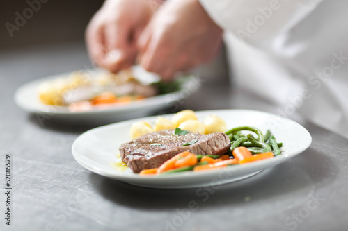 Photo: Chef preparing a dish in a kitchen restaurant Chef preparing a dish in a kitchen restaurant