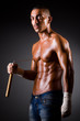 Muscular man with nunchucks on white