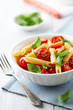 Penne with roasted cherry tomatoes and basil leaves