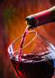Photo: Wine pours into the glass of the bottle Wine pours into the glass of the bottle
