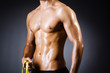 Muscular man measuring his muscles