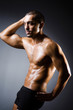 Photo: Muscular man in dark studio Muscular man in dark studio