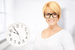 woman holding big clock