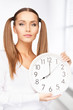 woman holding big clock